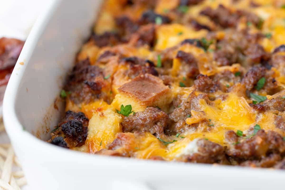 sausage and egg casserole in a white casserole dish.