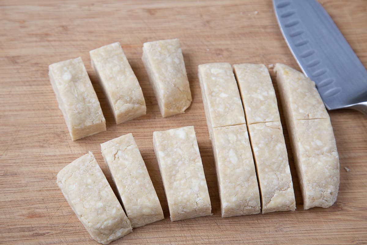 pieces of empanada dough on a cutting board.