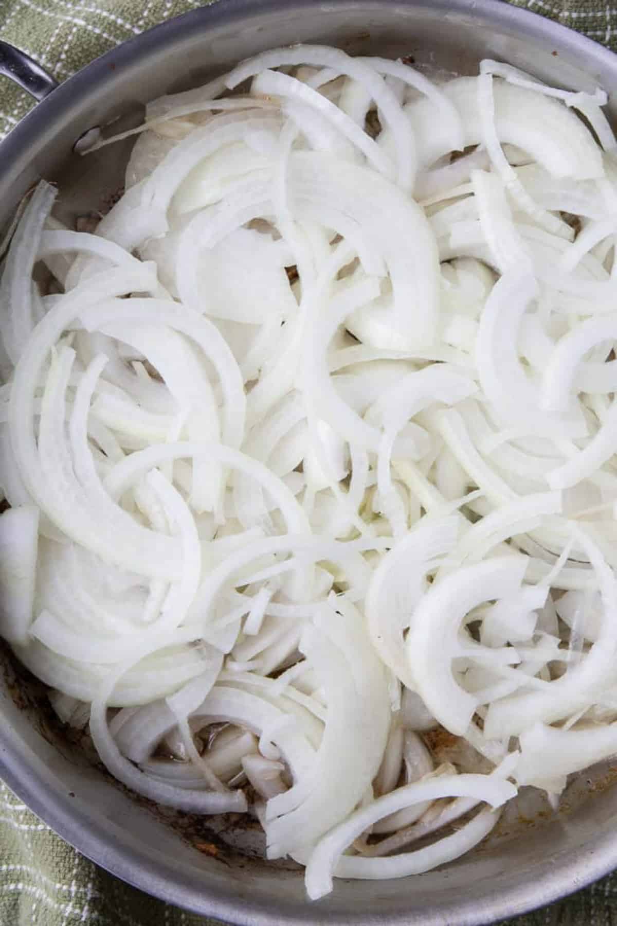 sliced onions in a skillet.