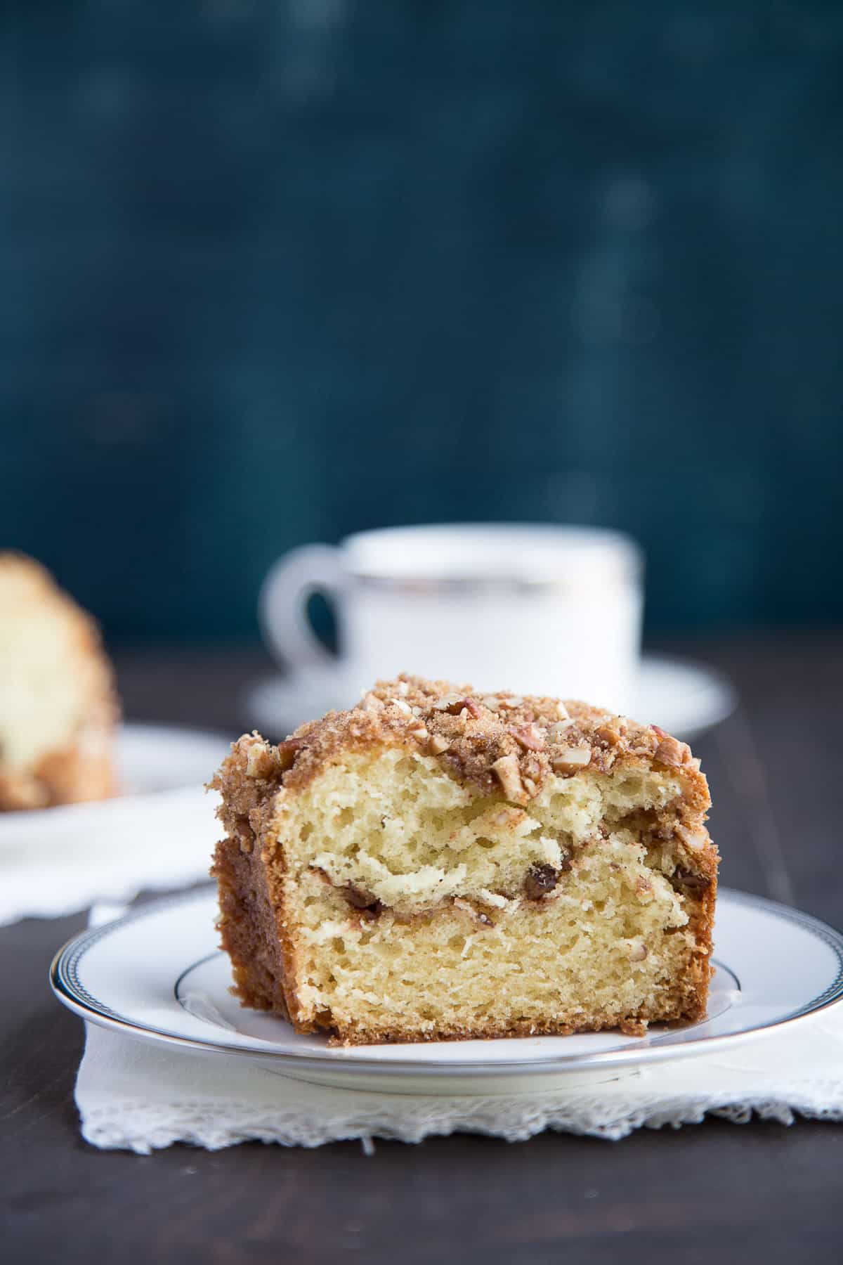 slice of sour cream coffee cake on a white plate.