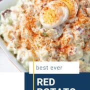 red potato salad topped with paprika and hard boiled eggs.