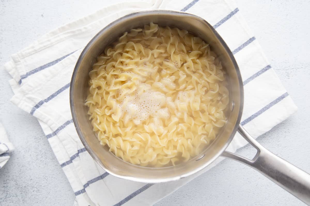 egg noodles cooking in a saucepan.