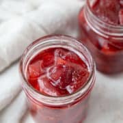 glass jar filled with strawberry preserves.