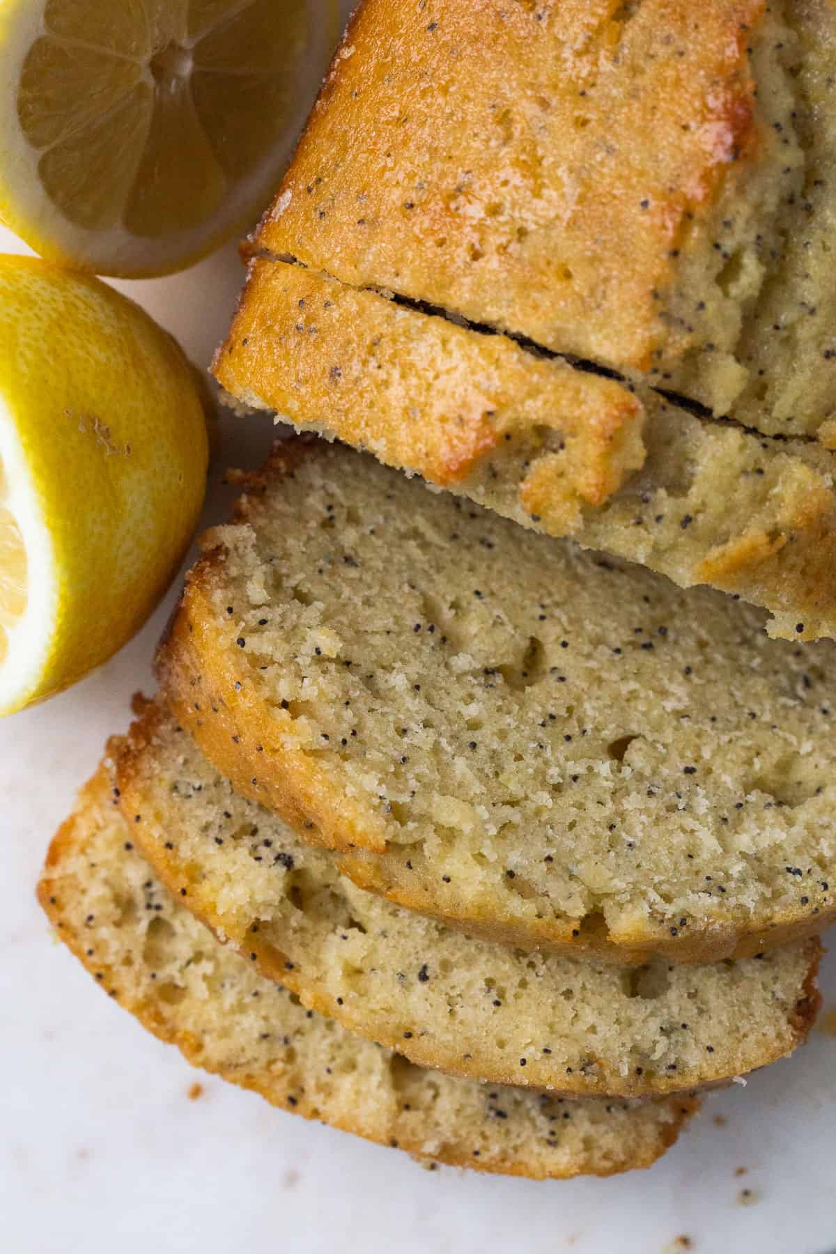 loaf of lemon poppy seed bread with slices cut off.