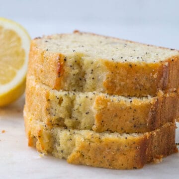 three slices of lemon poppy seed bread stacked up.