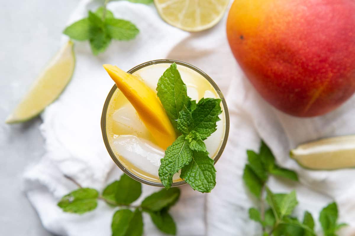 mango mojito garnished with mango and mint.