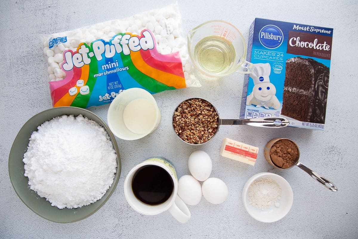 marshmallows, cake mix, eggs, and other ingredients on a white table.