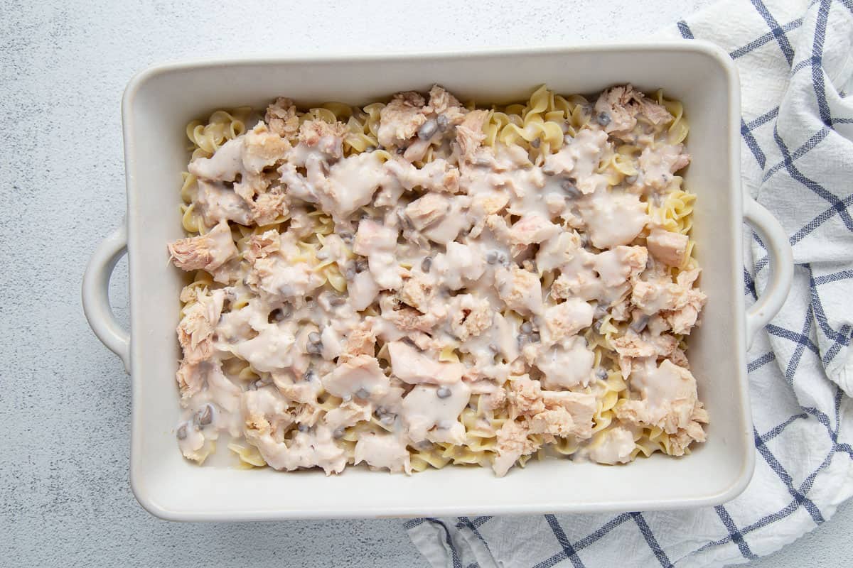 uncooked tuna noodle casserole in a white dish.