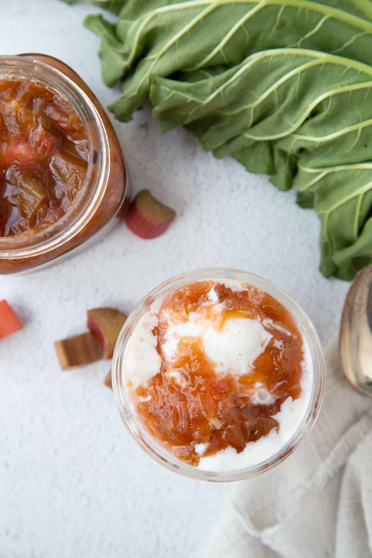 rhubarb sauce over ice cream in a parfait dish.