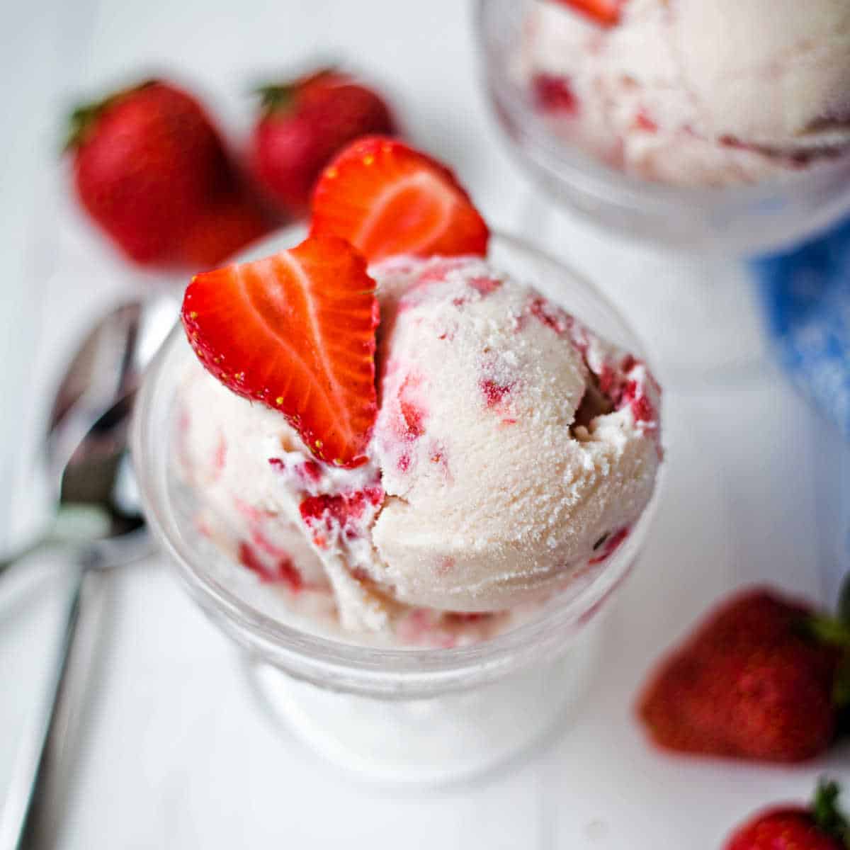 strawberry ice cream topped with strawberries.