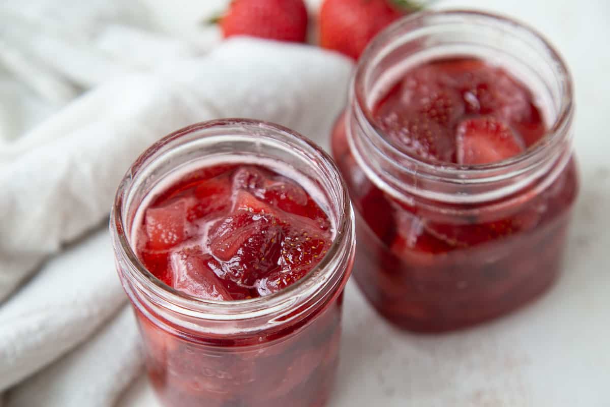 glass jars filled with strawberry preserves.