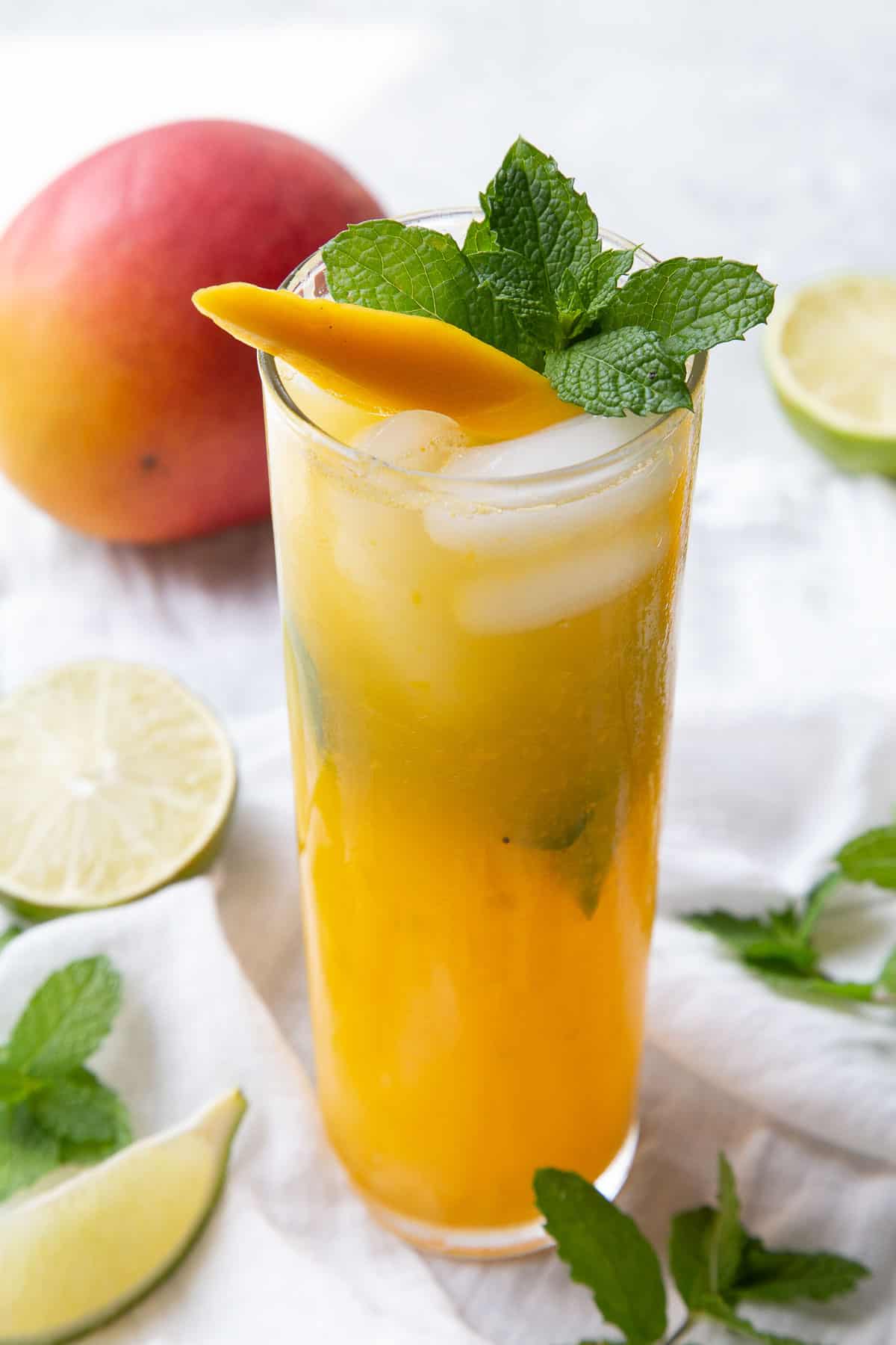 mango mojito garnished with mango and mint.