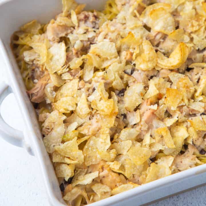 tuna noodle casserole with potato chips in a white dish.