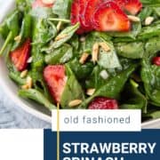 strawberry spinach salad in a low white bowl.