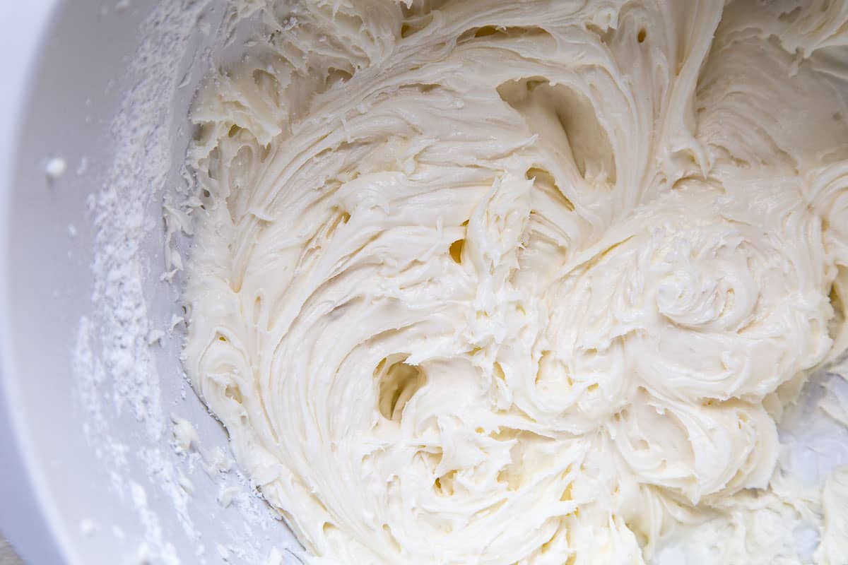 cream cheese frosting in a white bowl.