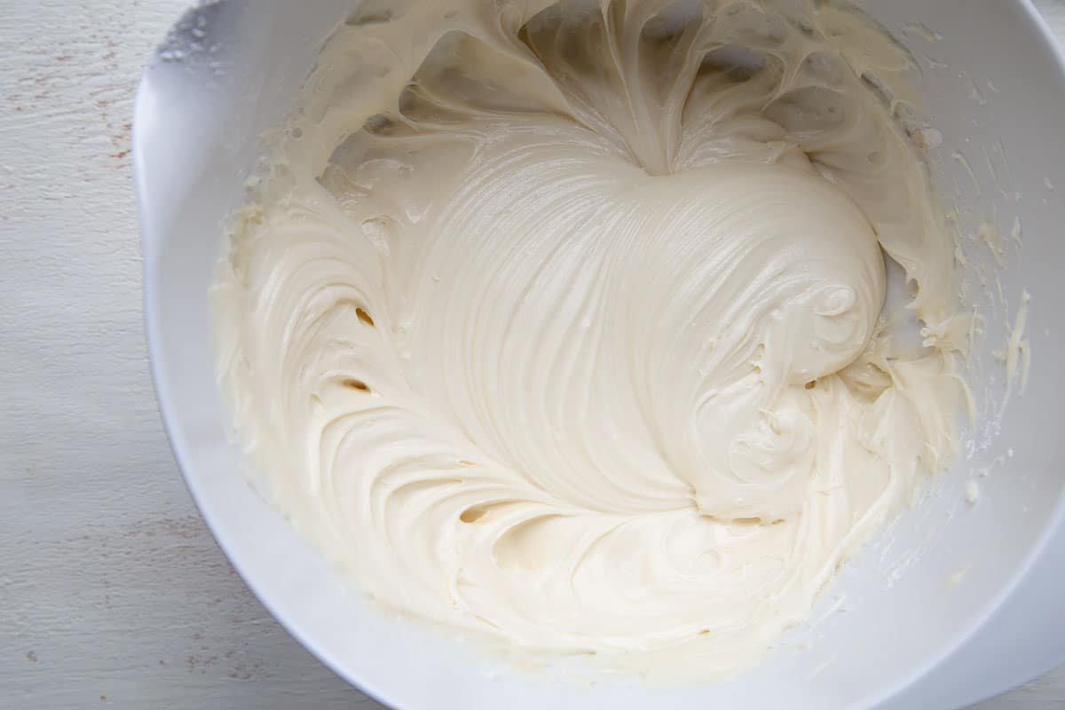 cream cheese frosting in a white bowl.