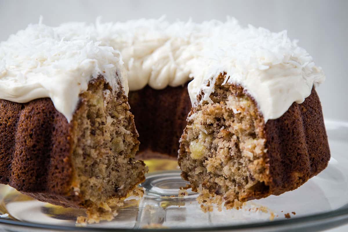 hawaiian bundt cake, cut open, on a glass cake stand.