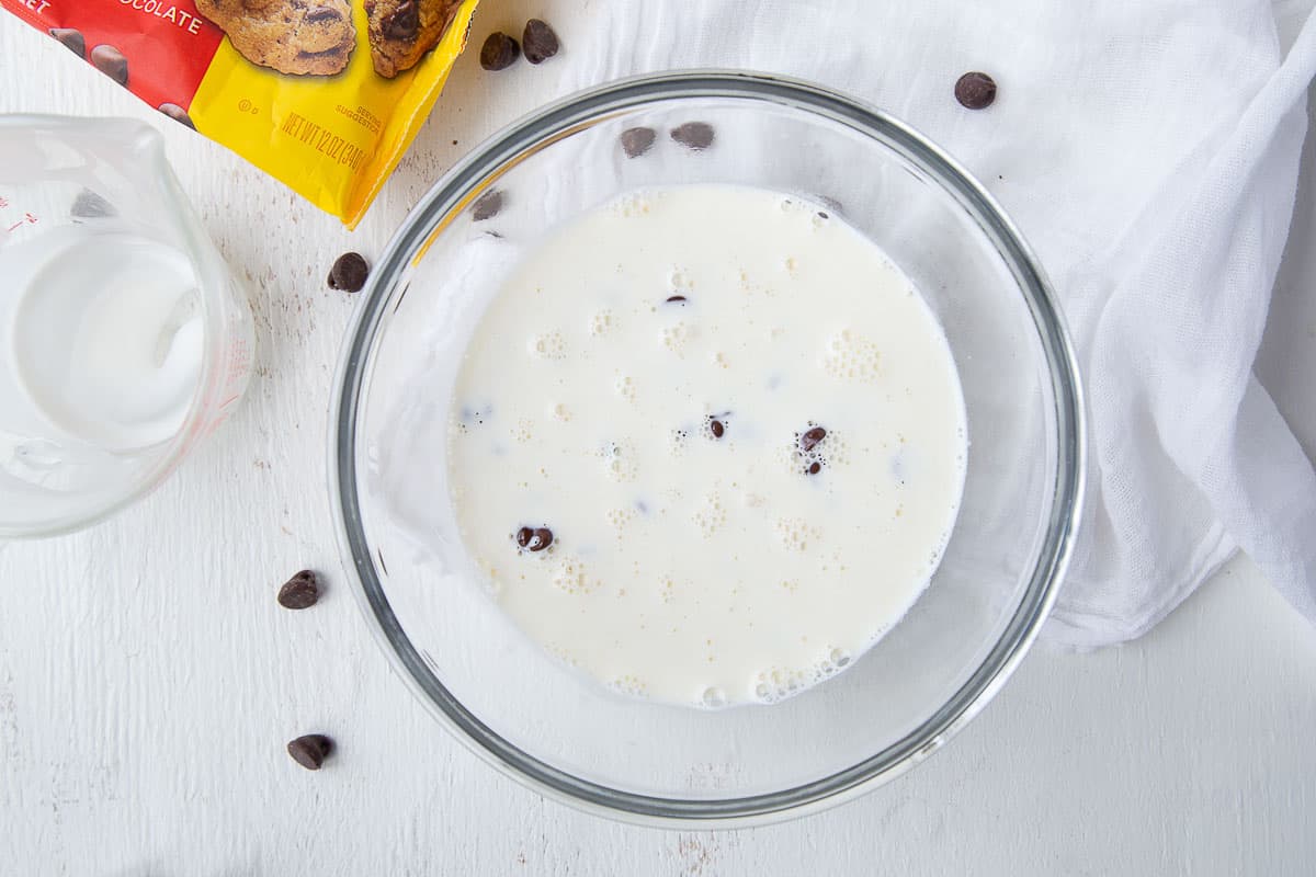heavy cream and chocolate chips in a glass bowl.