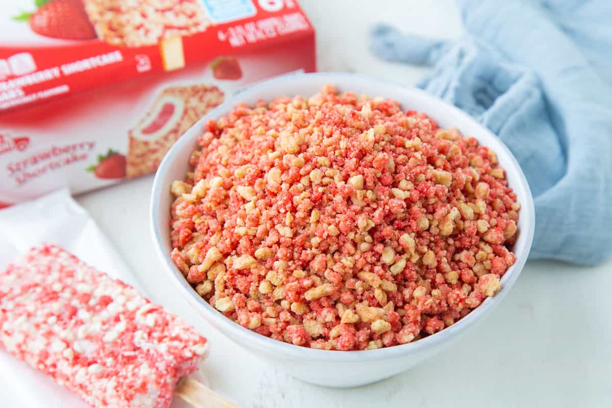 bowl of strawberry crunch next to a strawberry shortcake ice cream bar.