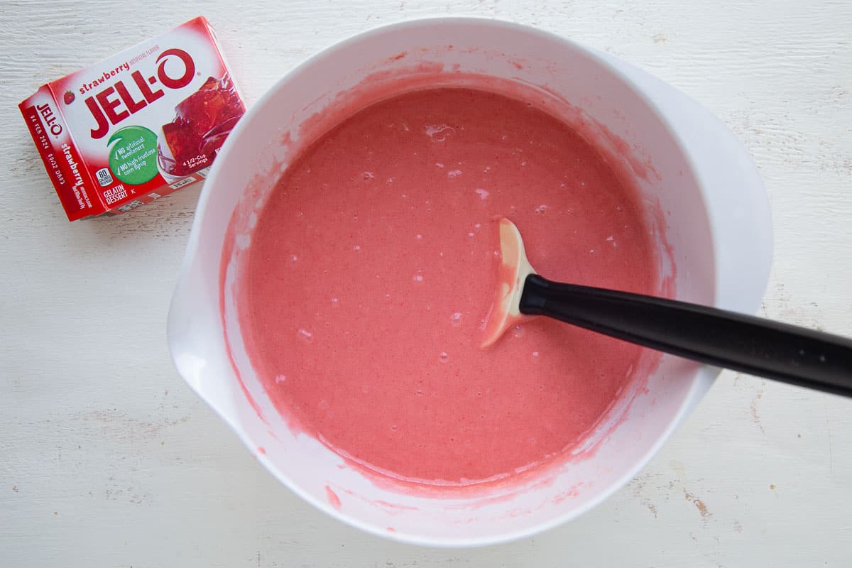 red cake batter in a white bowl.