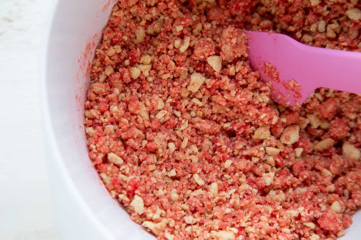 uncooked strawberry crunch topping in a white bowl.