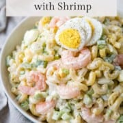 shrimp macaroni salad topped with hard boiled egg slices.
