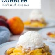 peach cobbler topped with a scoop of vanilla ice cream.