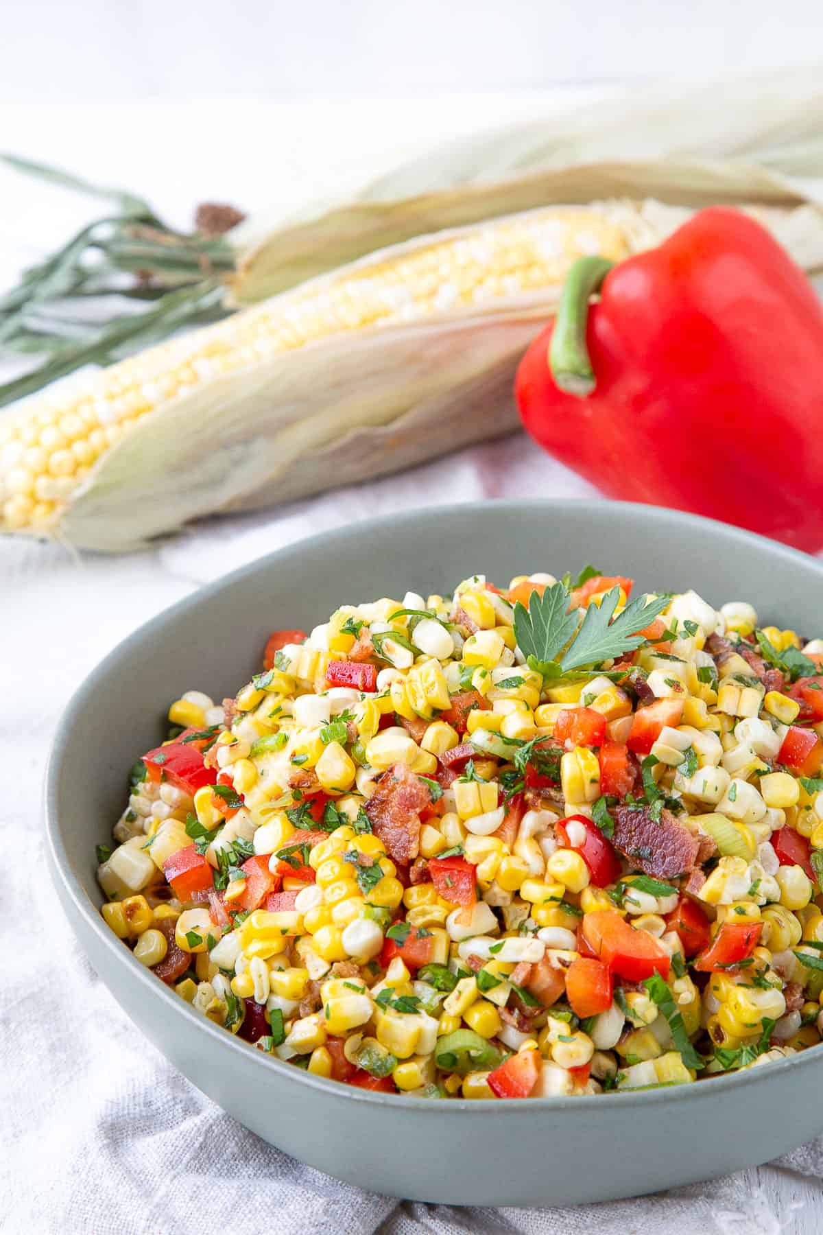 grilled corn salad in a green bowl.