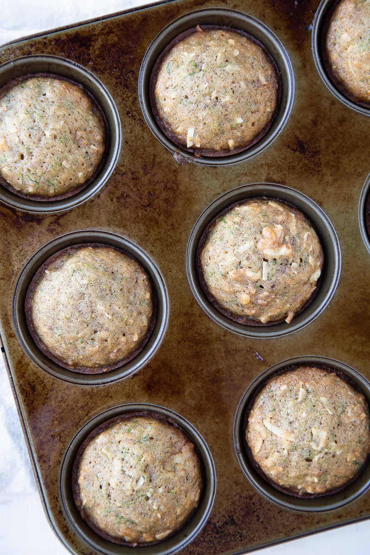 zucchini muffins in a muffin tin.