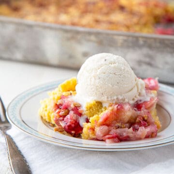 slice of cherry dump cake topped with vanilla ice cream.