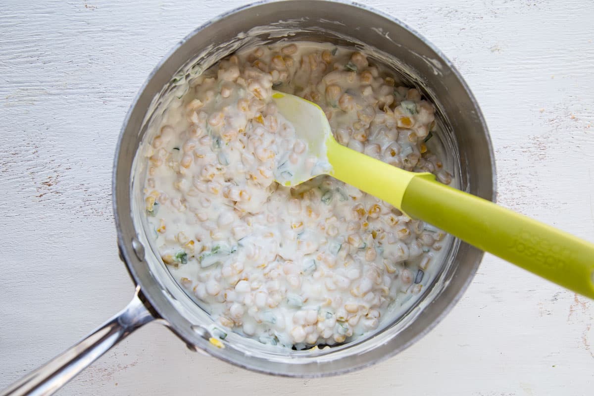 cream cheese and corn mixture in a saucepan.