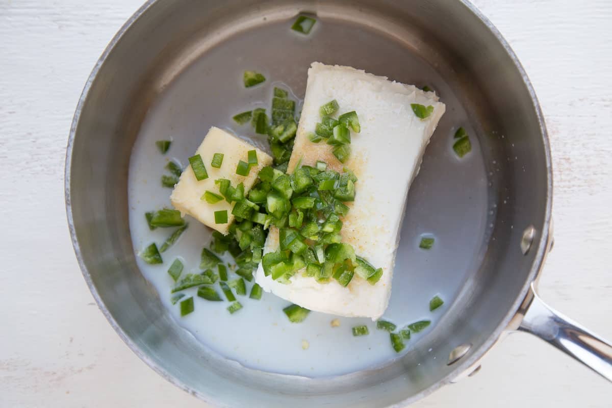 cream cheese, butter, and jalapeno in a saucepan.