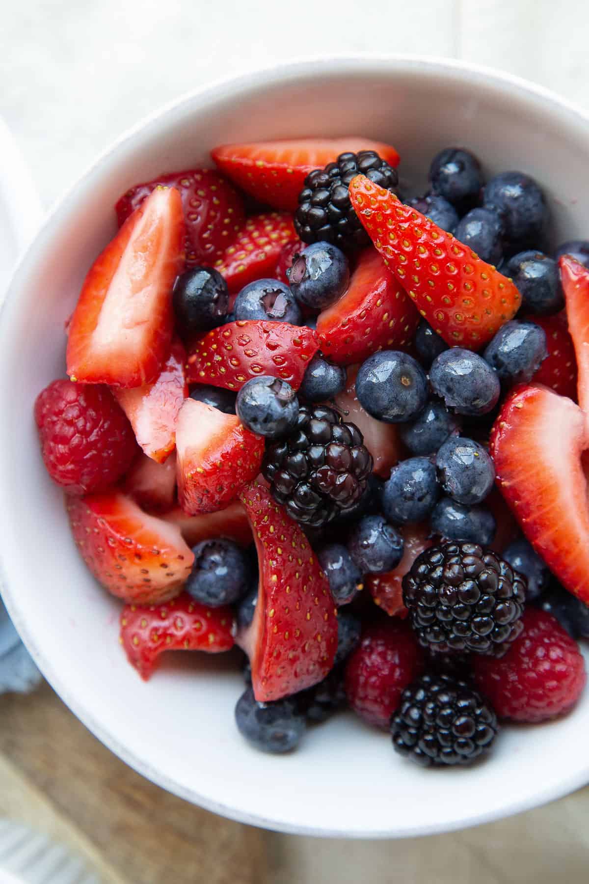 fresh berries in a white bowl.