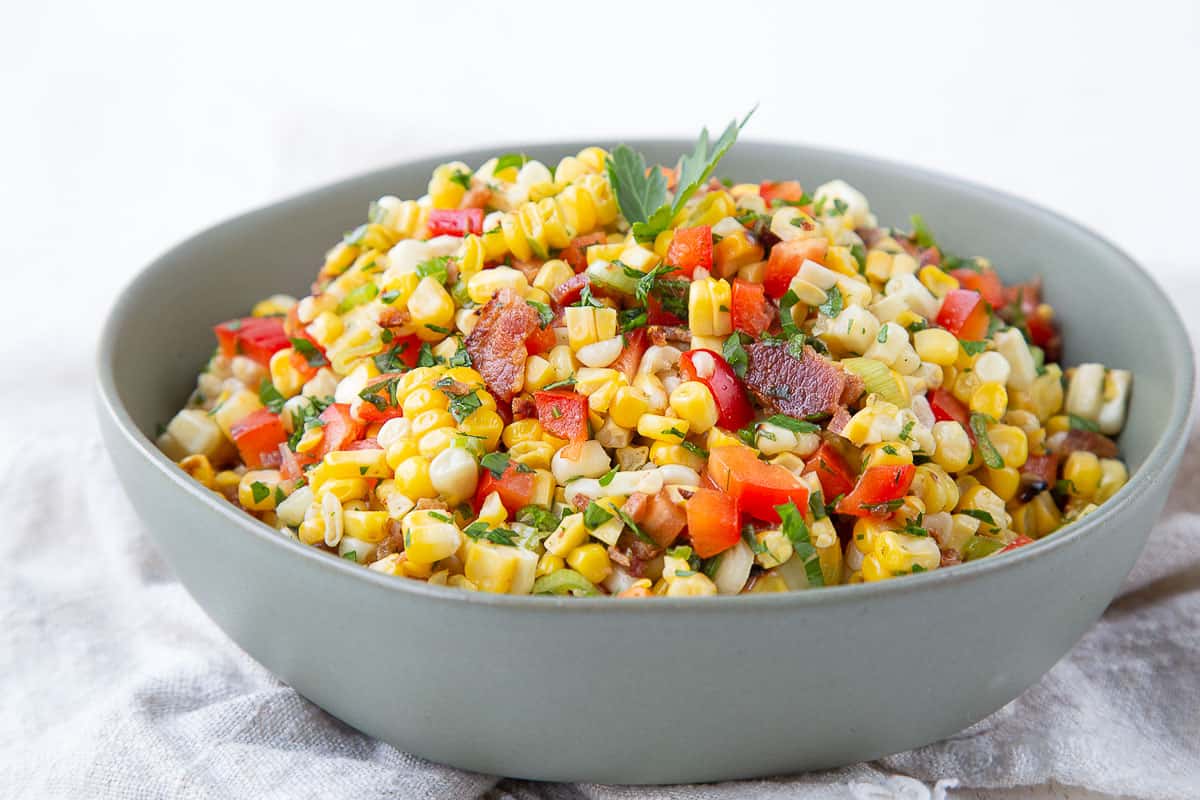 grilled corn salad in a green bowl.