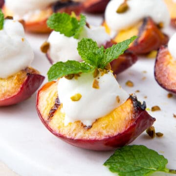 grilled peaches with honey whipped cream, pistachios, and fresh mint springs.