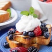 grilled pound cake slices topped with berries and whipped cream.
