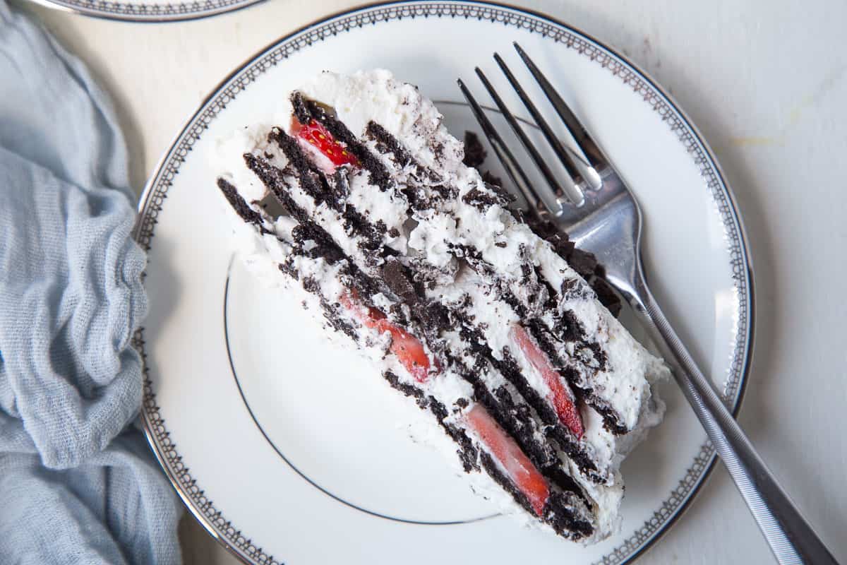 slice of icebox cake on a white plate with a fork.