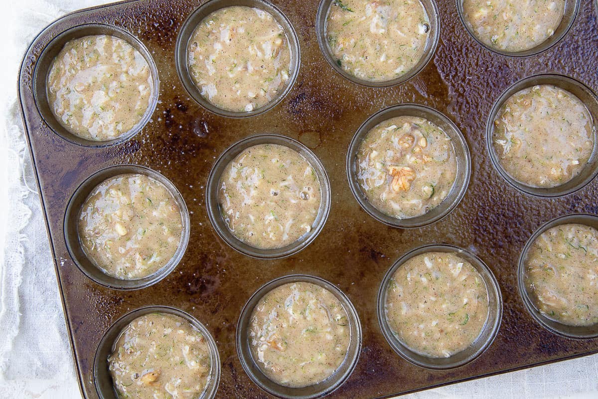 raw muffin batter in a muffin tin.