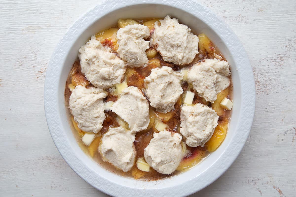 unbaked peach cobbler topped with bisquick biscuits.