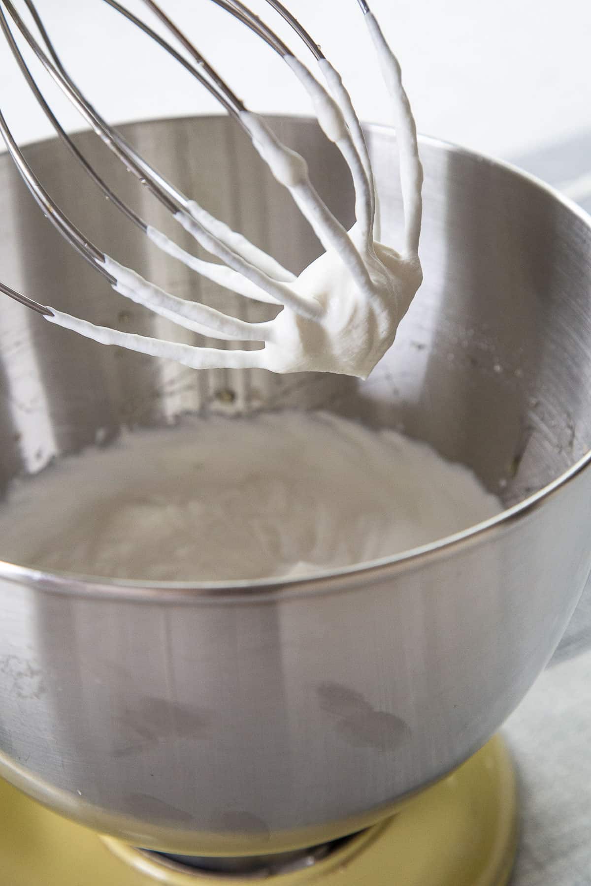 whipped cream in a stand mixer with a whisk attachment.