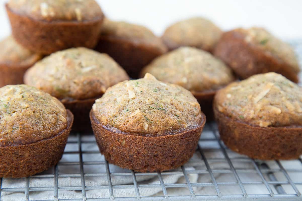 zucchini muffins on a wire rack.