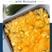 zucchini casserole topped with cheese in a gray dish.