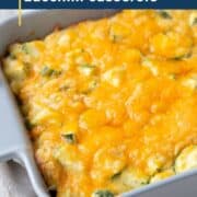zucchini casserole topped with cheese in a gray dish.