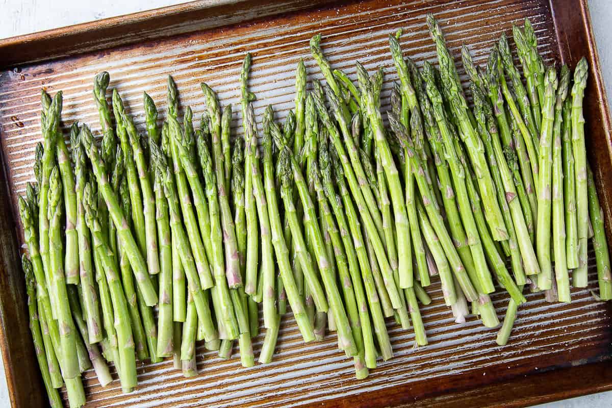 asparagus with oil on it on a sheet pan.