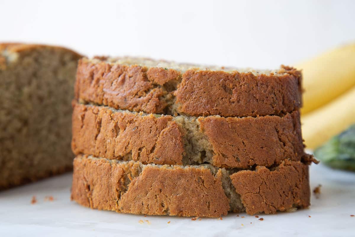 three slices of zucchini bread stacked on one another.