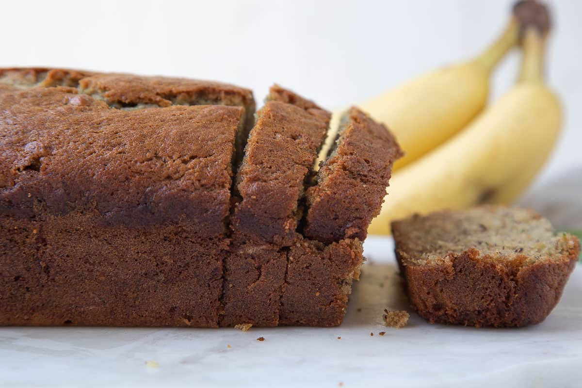 loaf of zucchini banana bread with slices cut off.