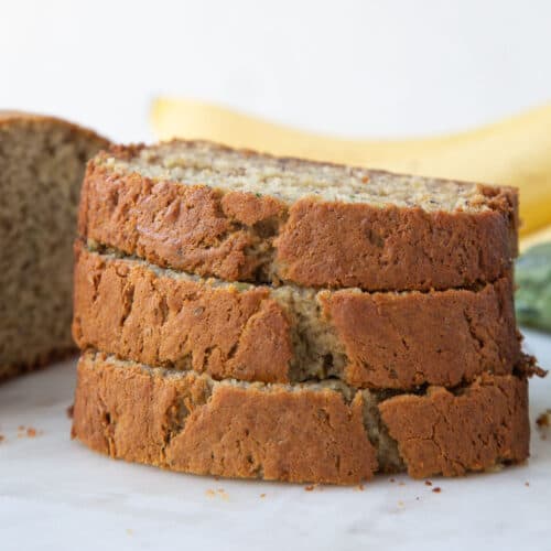 three slices of banana zucchini bread stacked on top of each other.
