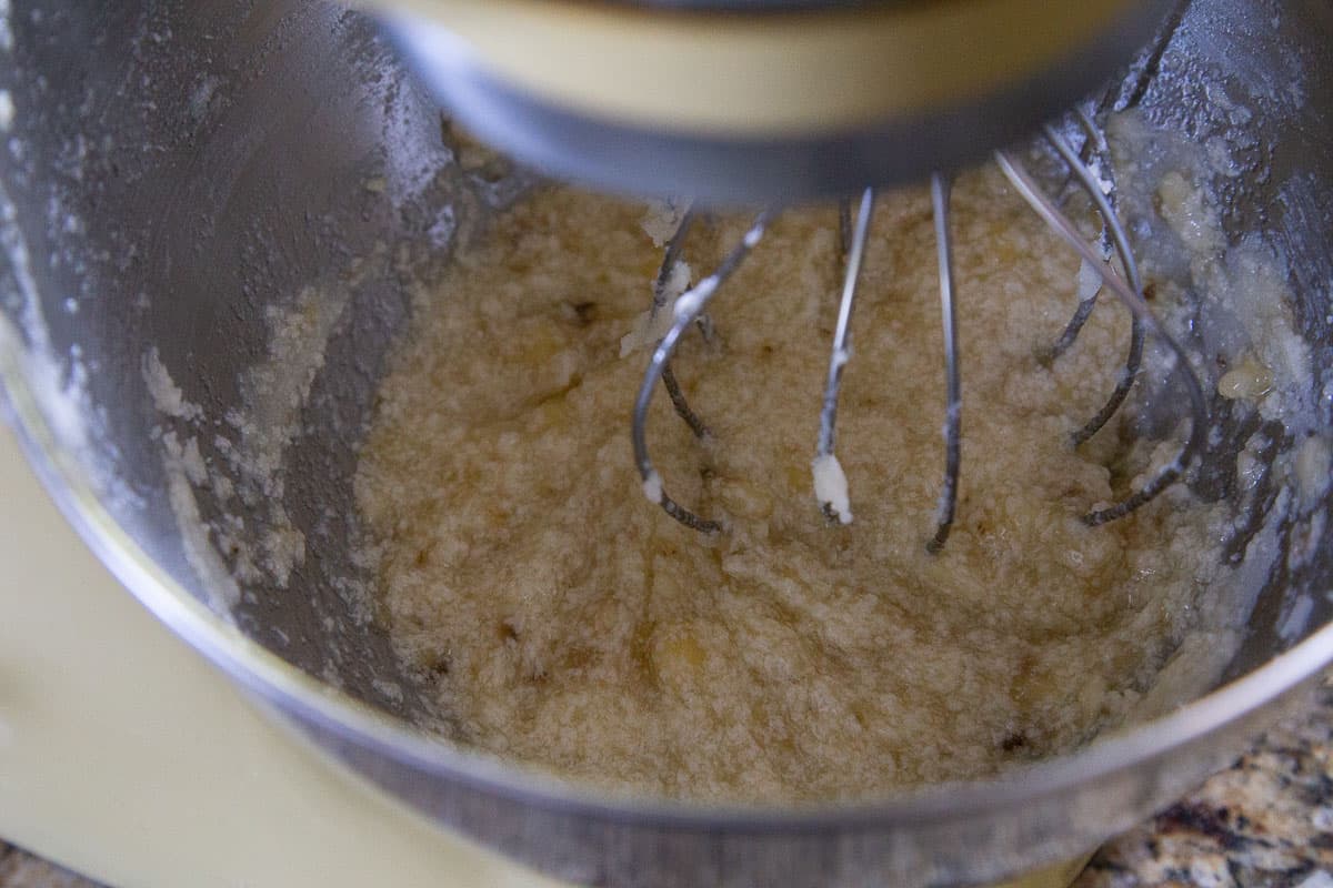 yellow stand mixer with banana zucchini bread batter in it.