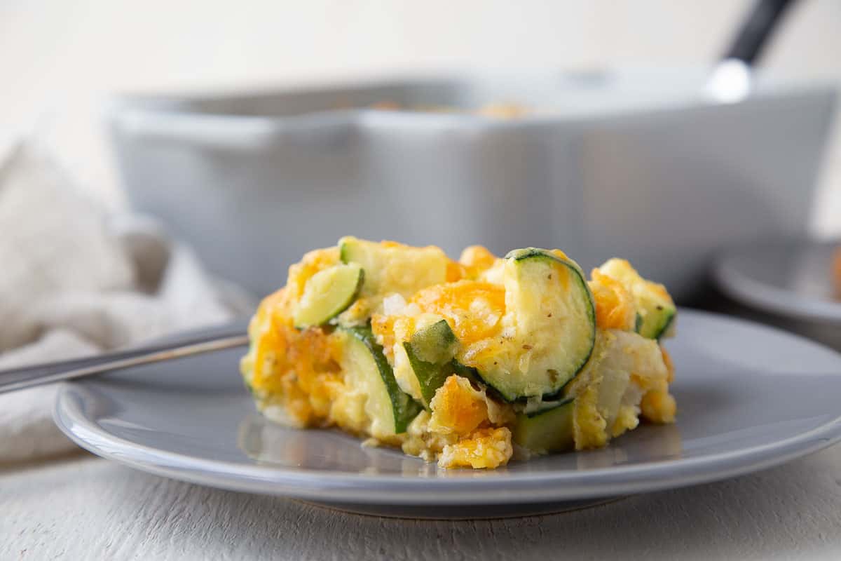 slice of zucchini casserole on a gray plate.