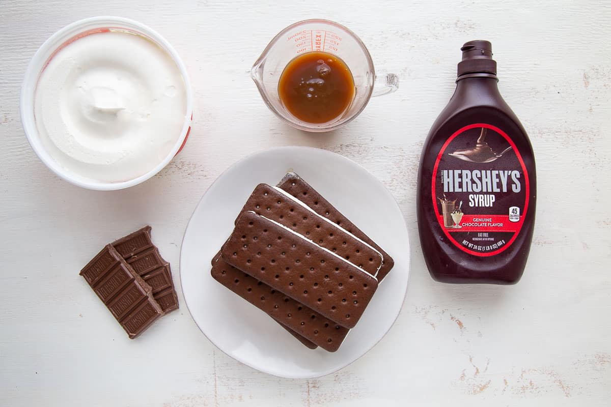 ingredients for an ice cream sandwich dessert on a white table.